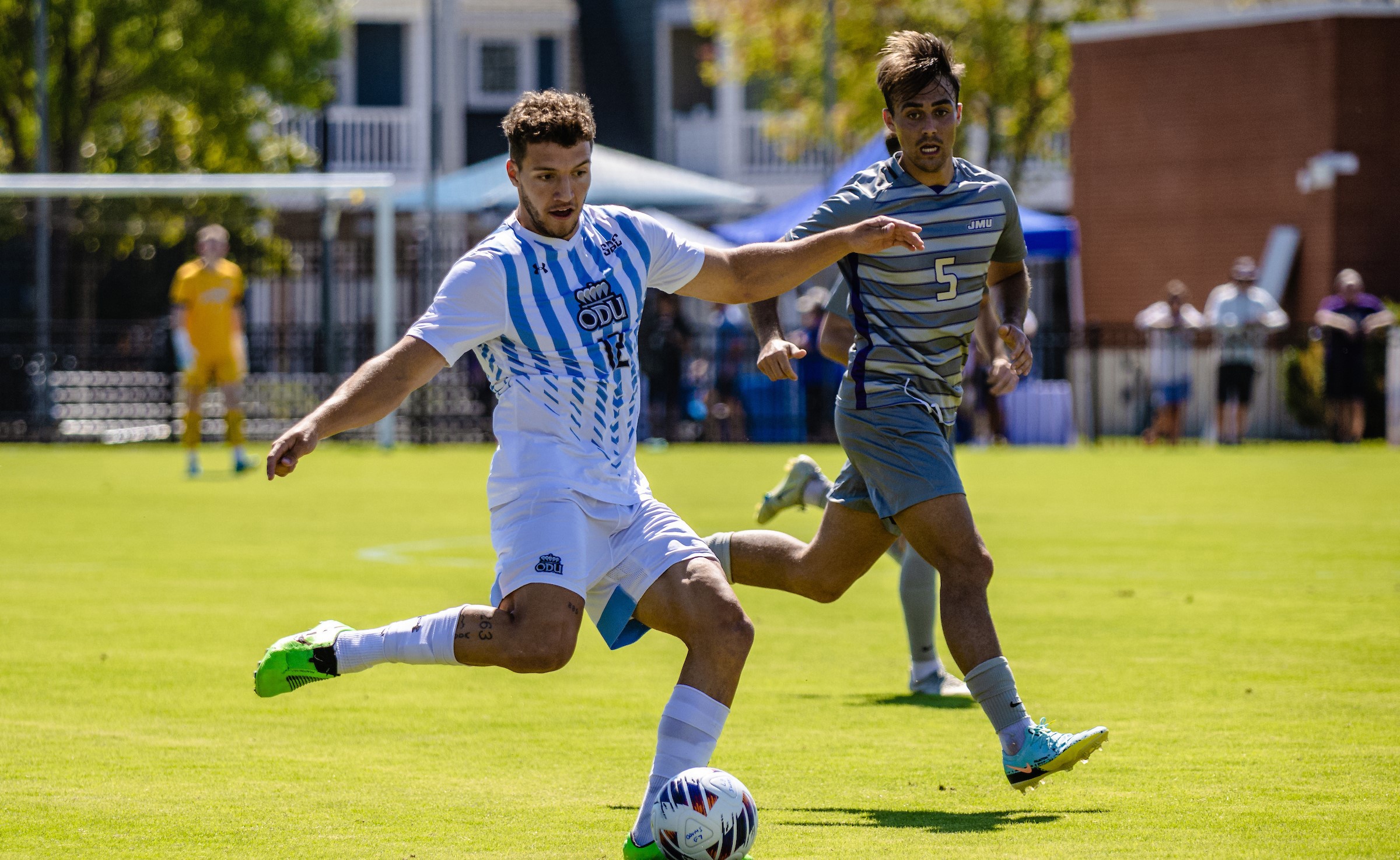 mens soccer player kicking a ball